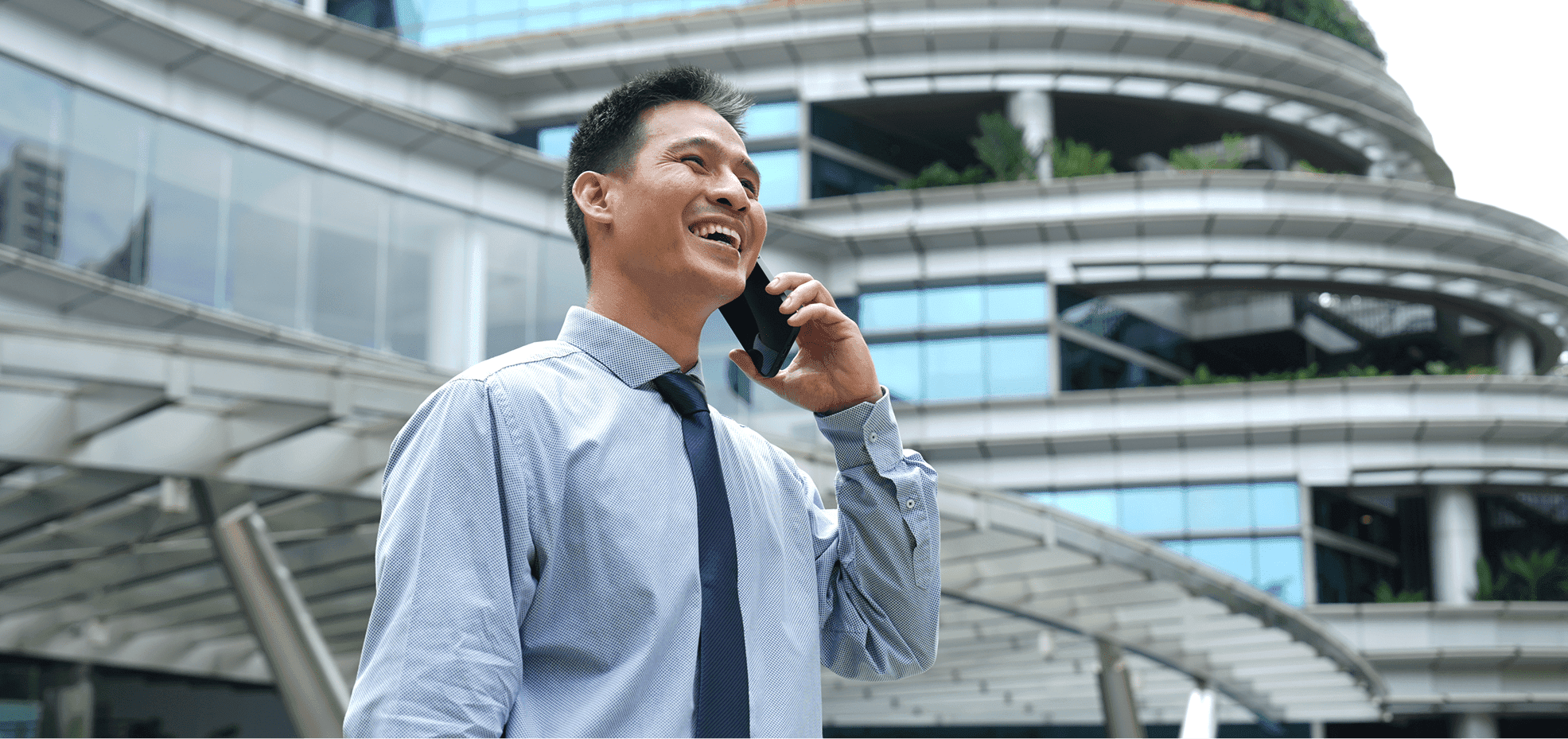 Man on a phone call outside a modern building